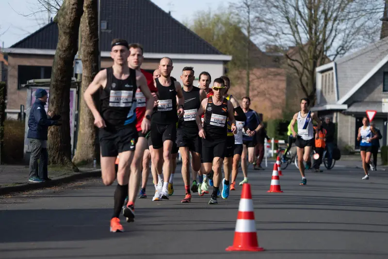 I believe this is when I (in the background, white singlet with blue and black diagonal stripe) was trying to quickly bridge the gap. Looking a lot more tired or struggling than I felt at the time.